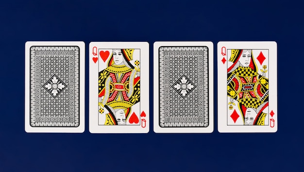 Photo queen playing cards with plain blue background for poker and casino copyspace