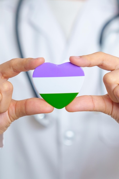 Queer Pride Day en LGBT Pride Month-concept Dokterhand met paars-witte en groene hartvorm met stethoscoop voor lesbische homoseksuele biseksuele transgender genderqueer en panseksuele gemeenschap
