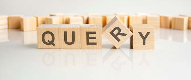 Query text on a wooden blocks, gray background