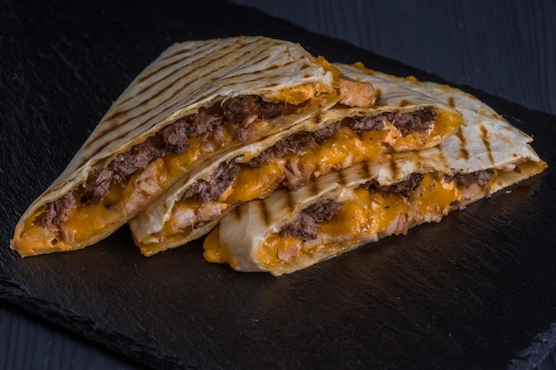 Quesadilla with beef Tortilla beef cheese white onion cheese sauce