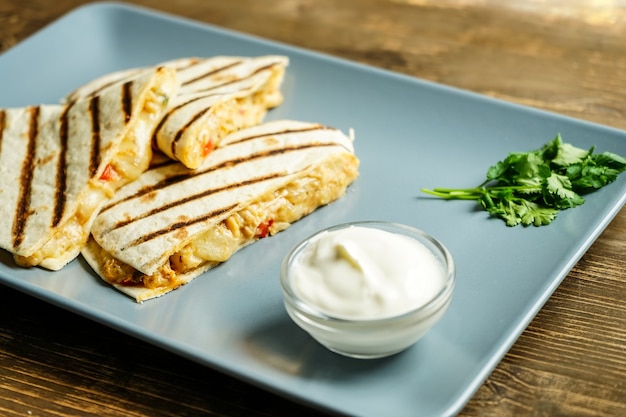 Quesadilla with chicken meat on plate