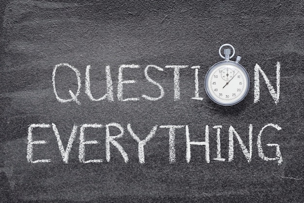 Question everything phrase written on chalkboard with vintage precise stopwatch