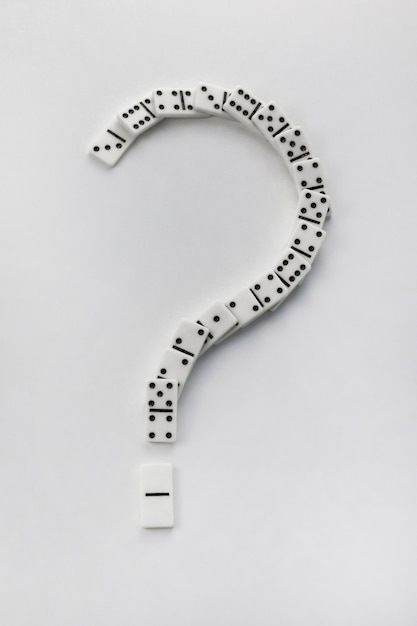 Photo question mark made from domino bones on white