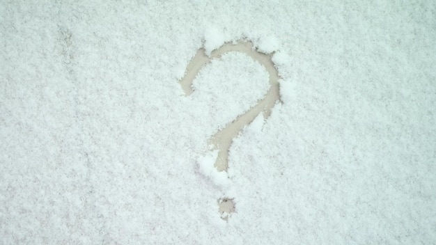 Question mark painted on white snow closeup