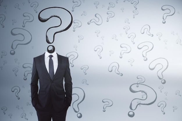 Question mark sketch headed businessman on grey background with copy space Confusion and think concept