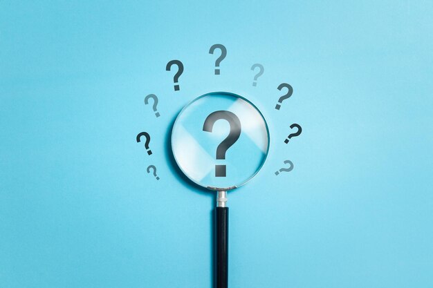 Photo question marks concept magnifying glass choos question mark for confusion faq ask question or solution