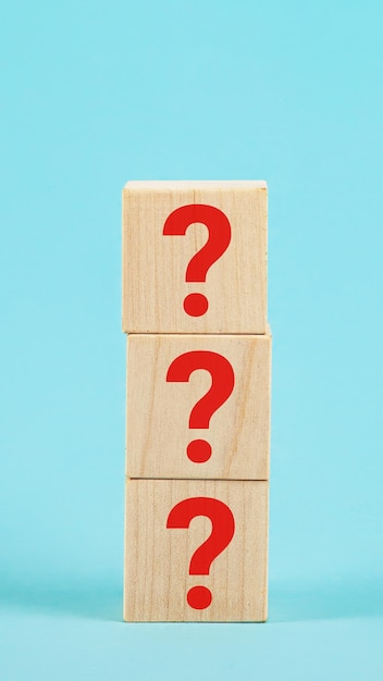 QUESTION The shape of a wooden cube block with a question mark symbol on a blue background