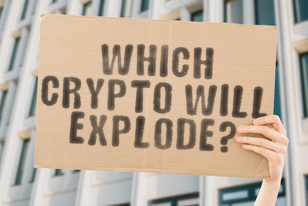 The question Which crypto will explode is on a banner in men's hands with blurred background Blast Cyberspace Exploding Economic Earnings Budget Economical Commercial Saving Profitable