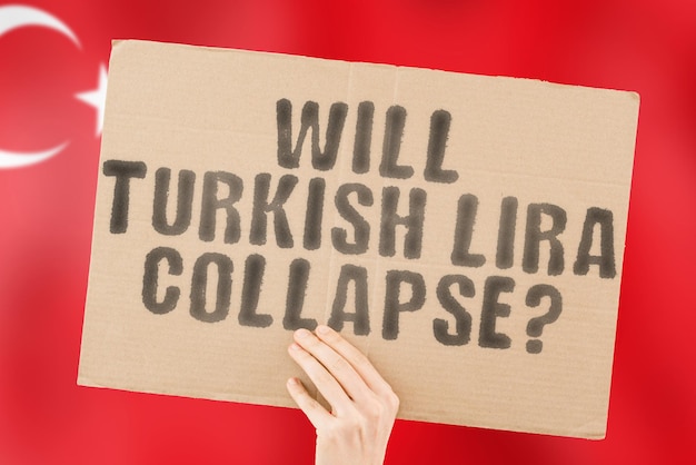 The question " Will Turkish lira collapse? " on a banner in men's hand. Money. Finance. Currency. Istanbul. Economical crisis. Rate. Loan. Destruction. Negative. Government