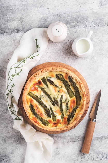 Quiche Homemade asparagus pie or quiche with cheese pecorino bacon and spinach on gray concrete light table background Asparagus and cheese tart French Quiche Top view