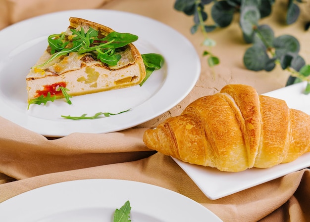 Quiche Lorraine with Croissant on White Plates