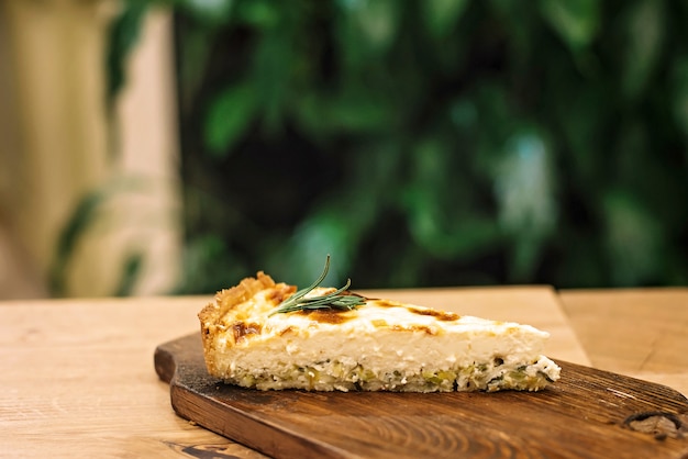 quiche pie with creamy filling on a wooden board