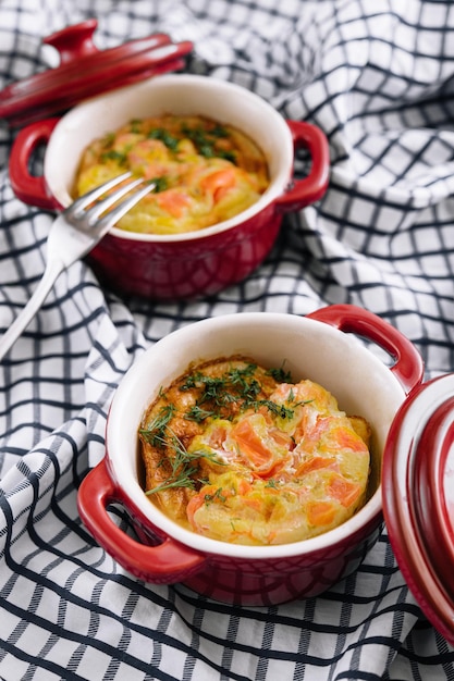 Quiche with salmon and vegetables on bowl