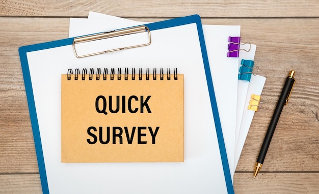 QUICK SURVEY is geschreven op een notitieblok op een bureau met kantooraccessoires