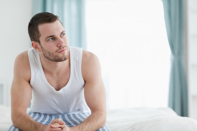 Quiet man sitting on his bed