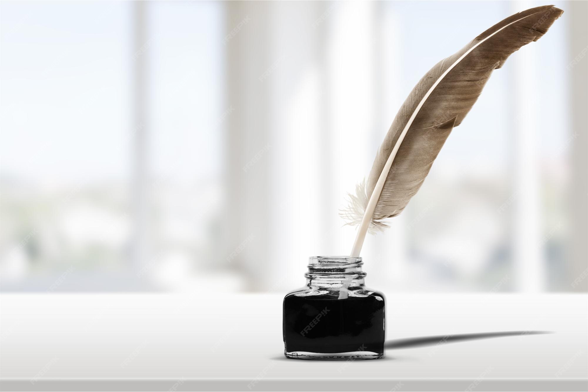 Premium Photo | Quill pen with inkwell on desk