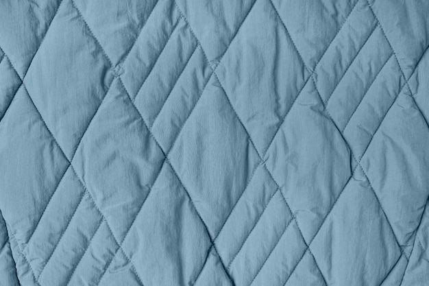 Fondo in tessuto trapuntato. coperta a trama blu o piumino