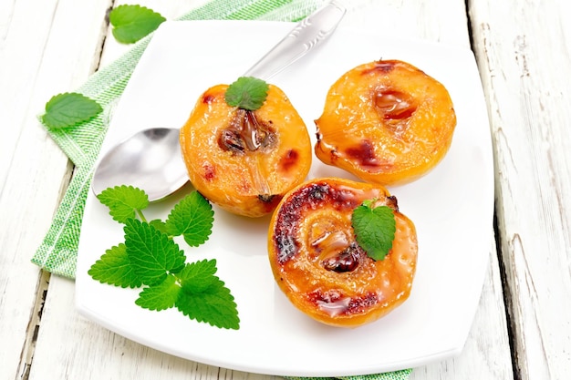 Quince baked with mint in plate on board