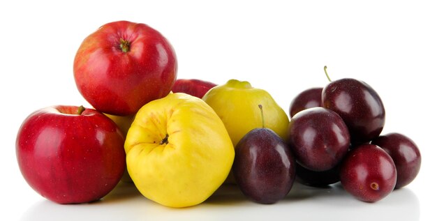 Quinces with apples and plums isolated on white