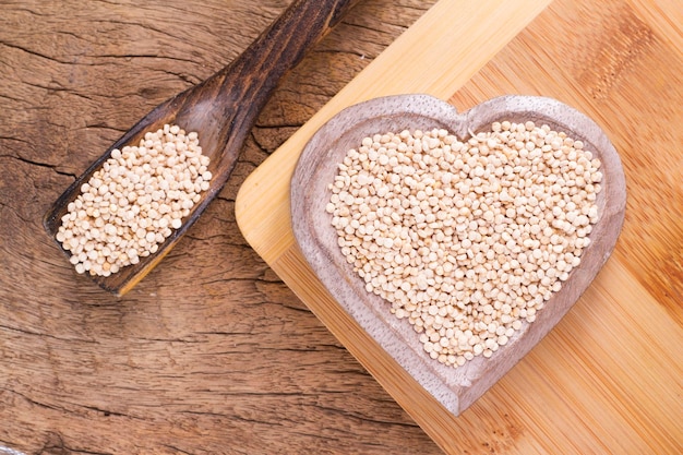 Quinoa beans in bowl on wooden background