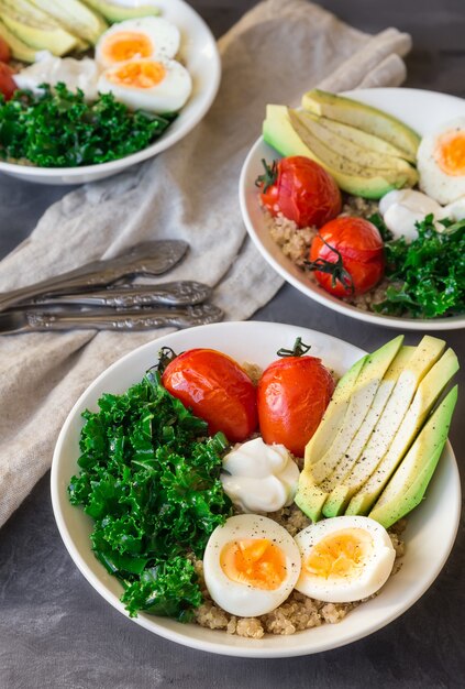 quinoa buddha bowls with baked tomatoes avocado kale boiled eggs and greek yogurt