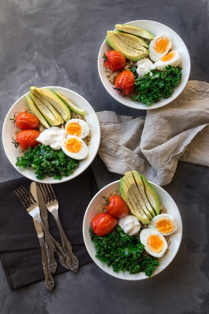 quinoa buddha bowls with baked tomatoes avocado kale boiled eggs and greek yogurt