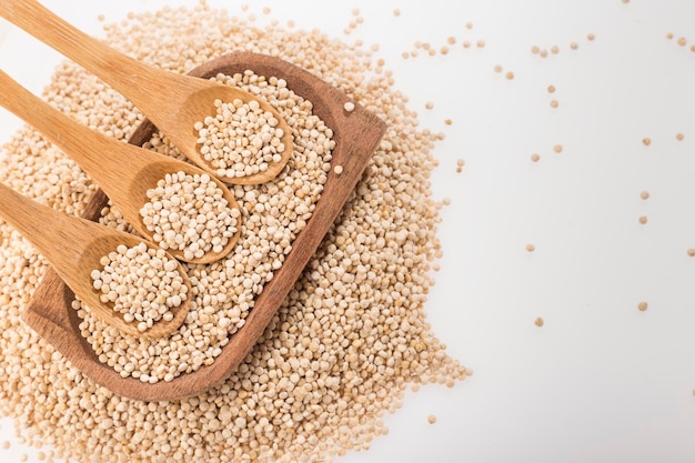 Quinoa grains in bowl isolated on white background Chenopodium quinoa