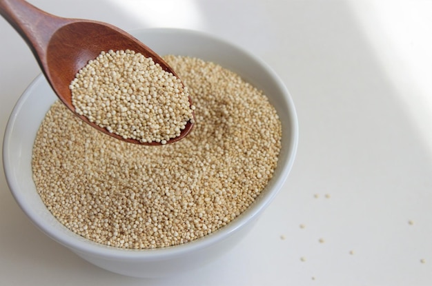 Photo quinoa seed for healthy eating in a white plate with a spoon