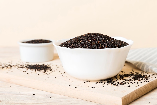 Quinoa seeds in bowl on colored background Healthy kinwa in small bowl Healthy superfood