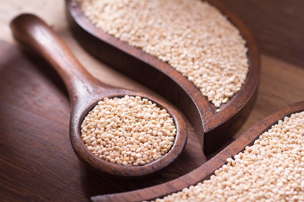 Quinoa seeds in bowl on rustic wood