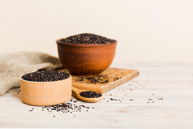 Quinoa seeds in bowl and spoon on colored background Healthy kinwa in small bowl Healthy superfood