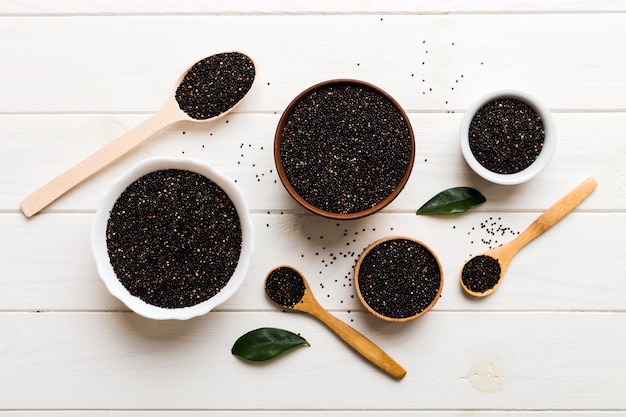 Quinoa seeds in bowl and spoon on colored background Healthy kinwa in small bowl Healthy superfood