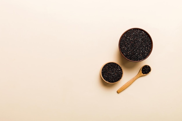 Quinoa seeds in bowl and spoon on colored background Healthy kinwa in small bowl Healthy superfood