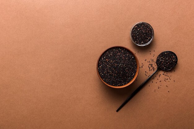 quinoa seeds in bowl and spoon on colored background Healthy kinwa in small bowl Healthy superfood