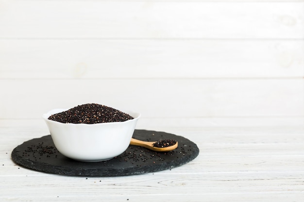 quinoa seeds in bowl and spoon on colored background Healthy kinwa in small bowl Healthy superfood