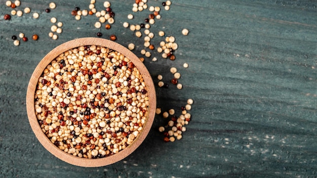 Quinoa seeds in wooden bowl on wooden background Healthy and gluten free food Long banner format top view