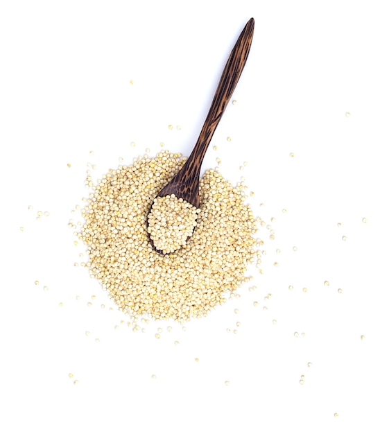 Photo quinoa seeds in wooden spoon isolated on white space. top view