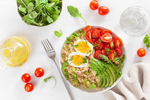 Quinoa with boiled egg, avocado, tomato, arugula. healthy breakfast