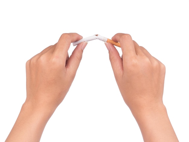 Quit smoking, human hands breaking the cigarette isolated on white background.