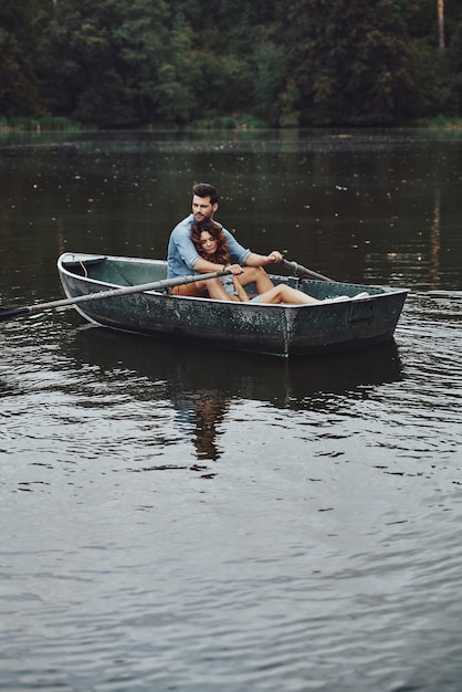 Quite moments together. Beautiful young couple embracing while enjoying romantic date on the lake