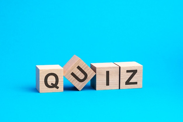 QUIZ text on wooden blocks business concept blue background