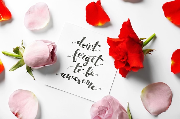 Quote Dont forget to be awesome written on paper with petals and flowers Top view