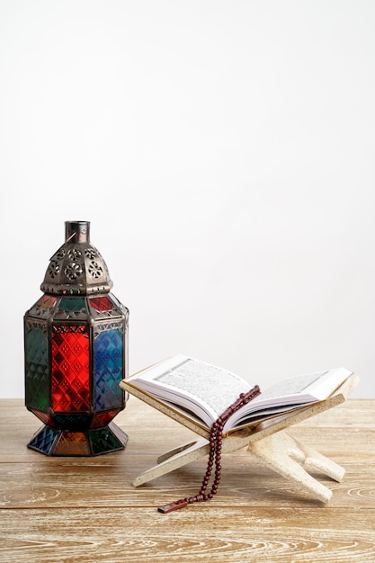 Quran arab lantern and pray beads on white