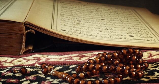 イスラム教の聖典コーランと数珠の写真を祈る