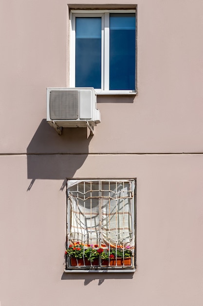 Raam in huis bedekt met een handdoek om te beschermen tegen direct zonlicht versus airconditioningsysteem. goedkope manier om een appartement te koelen in de hitte van de zomer