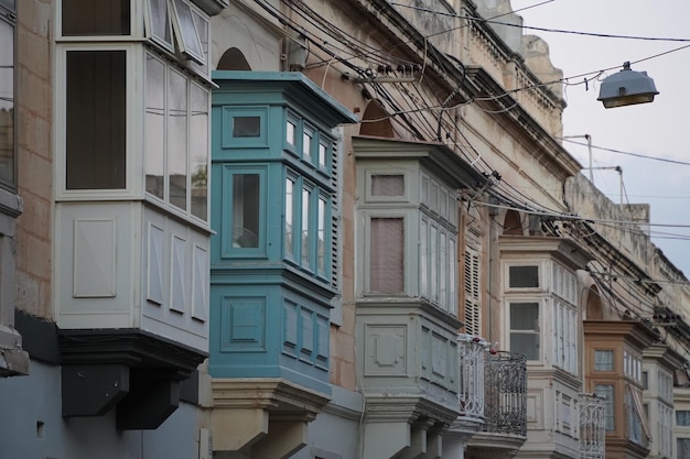 Rabat medieval village street view building in Malta painted bow windows