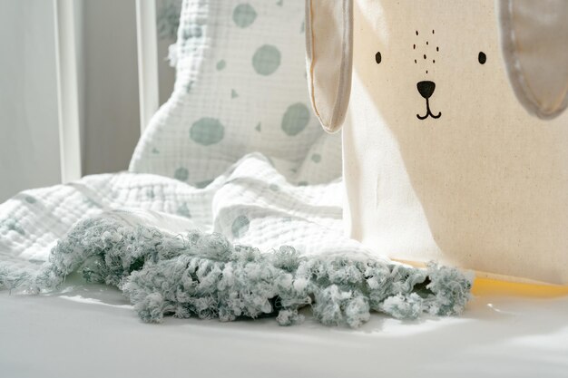Rabbit basket for toys and blanket in baby bed