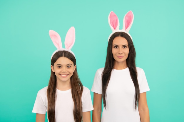 Rabbit family bunny hunt teen girl child and mom having fun kid\
and woman looking funny paschal spring holiday friendship mother\
and daughter wear bunny ears happy easter
