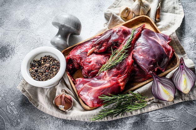 Rabbit meat. Raw fresh  farm rabbit on a wooden table with vegetables and spices