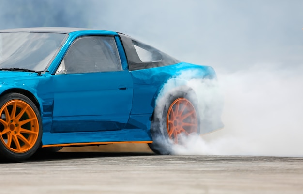 Race drift car burning tires on speed track